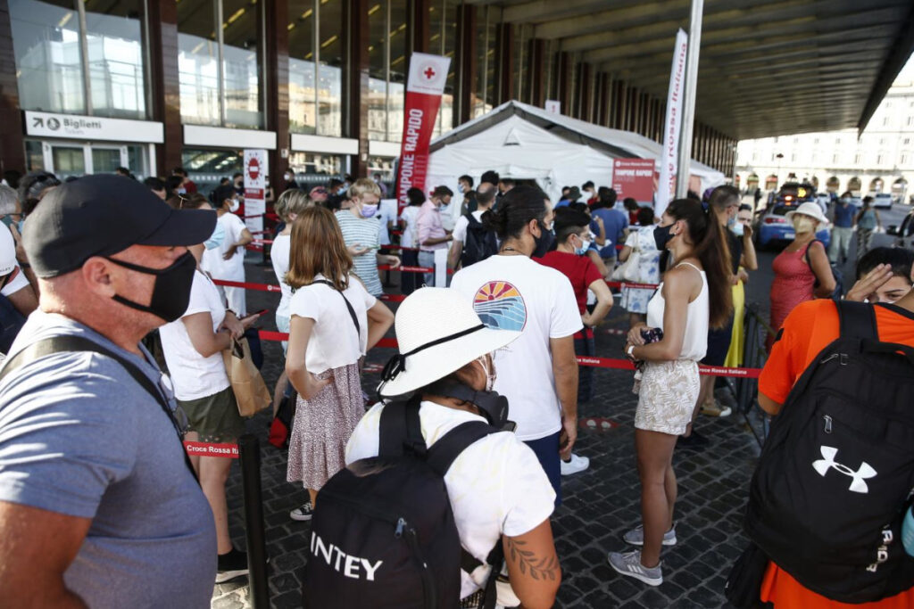 Stazione ferroviaria piena di persone tra distanziamento e mascherine