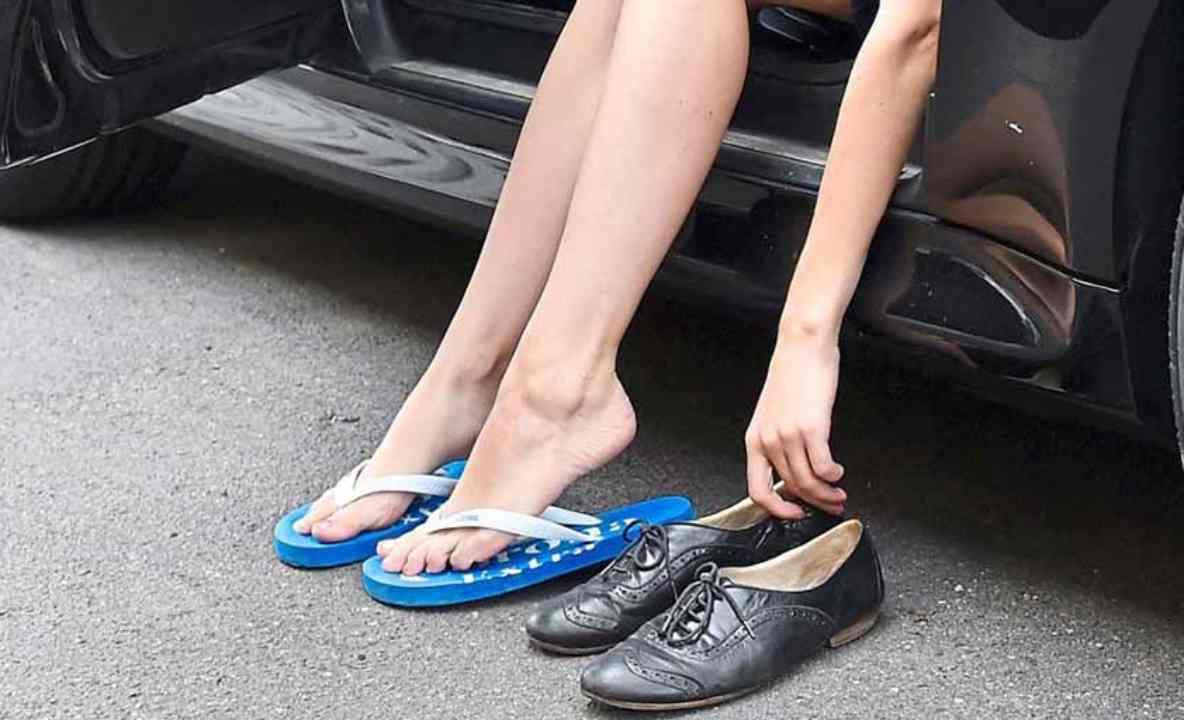 Una donna si cambia le scarpe per guidare
