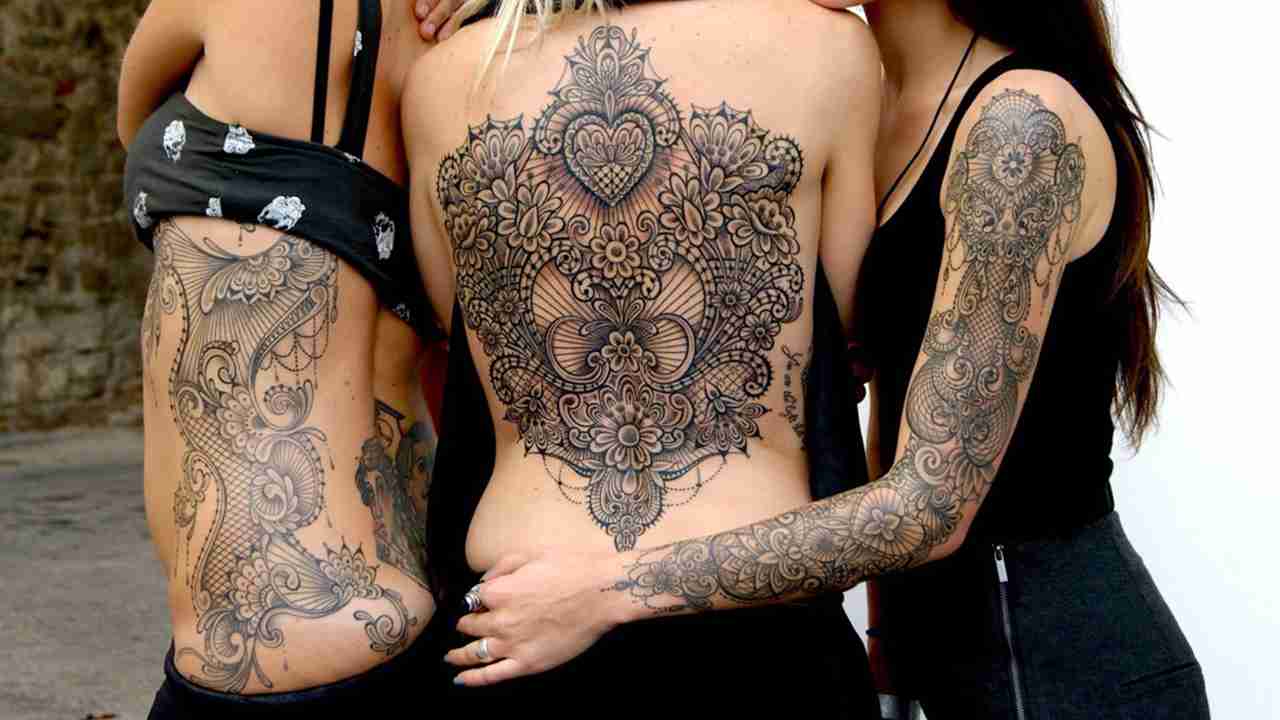 Tre modelle tatuate da Marco Manzo con stile ornamentale