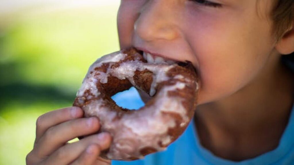 Un bambino che mangia una ciambella